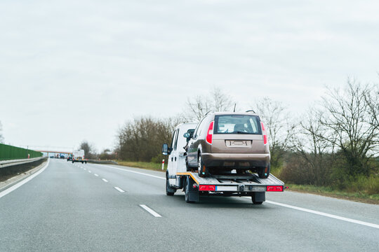 Car carrier driving on an empty rural road
