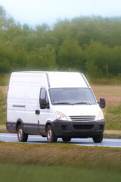 Fast delivery van carrying cargo on a quiet highway