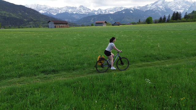Active woman cycling through rural scenery
