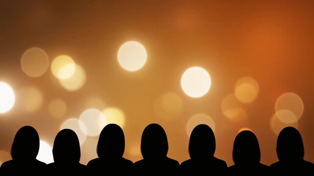 Silhouette of Female Audience Watching Warm Golden Bokeh Lights