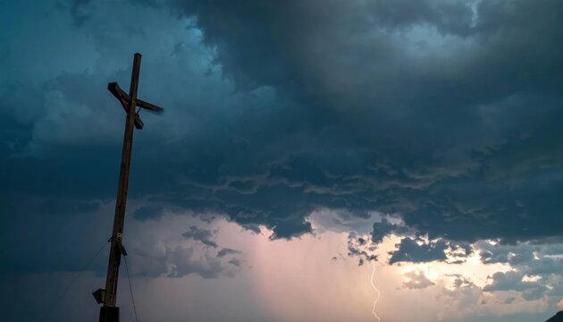 Wooden Cross Silhouetted Against Dramatic Stormy Sky with Pink Clouds.