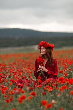 Woman poppy field sitting among vibrant red flowers wearing a floral crown serene summer portrait