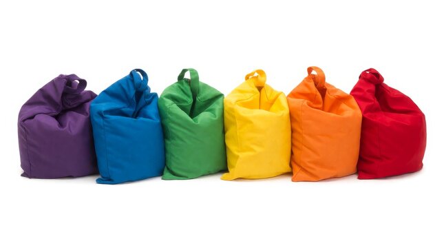 Six colorful bean bags arranged in rainbow sequence on clean white surface with lined rainbow color
