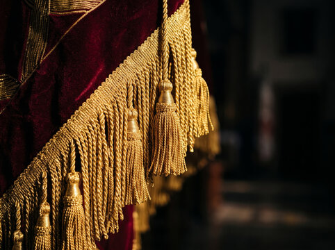 Rich red velvet ceremonial banner cloth decorated with gold tassel fringe