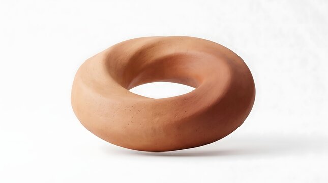 A smooth terracotta clay sculpture shaped like a twisted torus isolated on white.