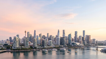 Obraz premium Modern city skyline with bridge and harbor at sunset