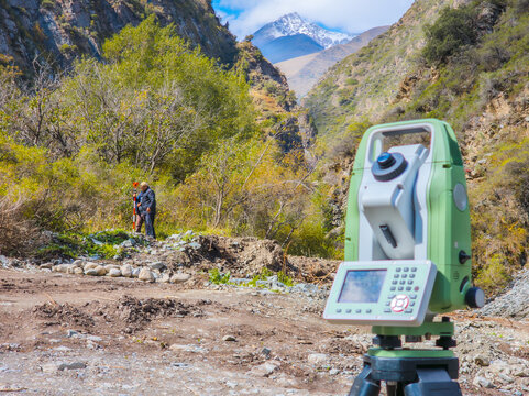 Surveying Instrument in Rugged Mountain Valley