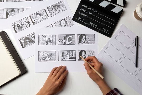 Creative film editing process with storyboard and clapperboard. Filmmaking and post-production work in progress.