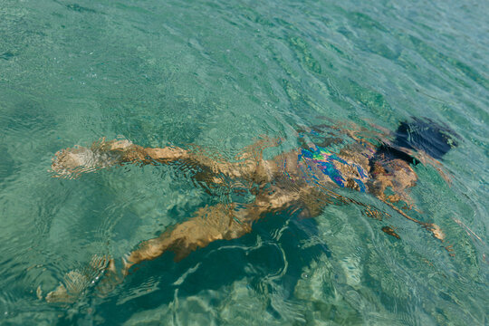 Girl Swimming in Transparent Seawater Viewed from Above