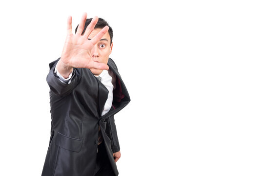 Scared handsome man demonstrating stop gesture