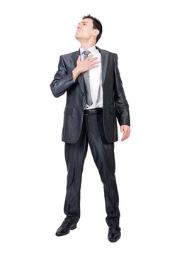 Serious man putting hand on chest and looking away, transparent background
