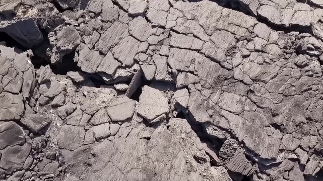Erta Ale volcano, Aerial view of cracked and solidified lava crust of the Erta Ale volcano, showing deep fissures and jagged volcanic rock formations in Zone 2, Afar, Ethiopia.
