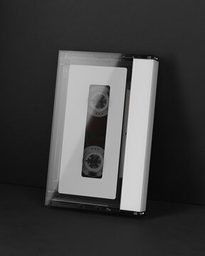 3d render. A mock-up of an audio cassette with a box on a black background. Retro aesthetics, clean composition, ideal for design and media projects.