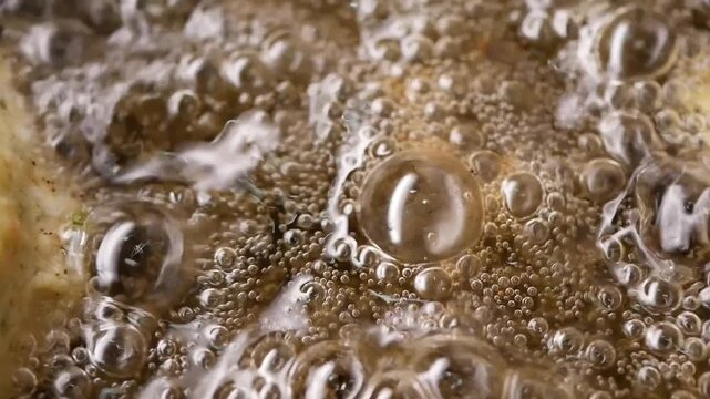 Cooking food in hot oil with bubbles rising