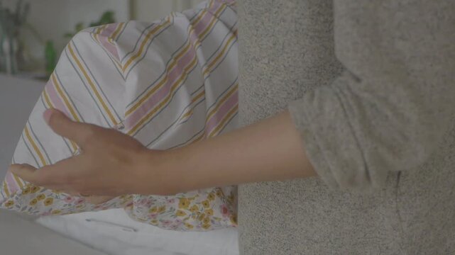 Making the bed with fresh sheets and pillows