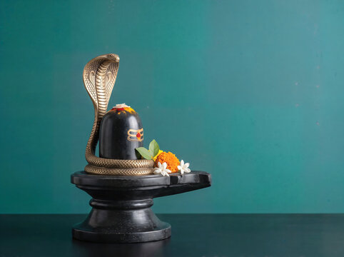Lord Shiva Mahadeva Symbol Shivlinga with cobra snake, traditional Hindu puja Naag Panchami, spiritual Mahashivratri worship concept Background. 