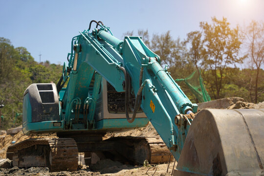 Building process city levee. Excavator dredging pond bank