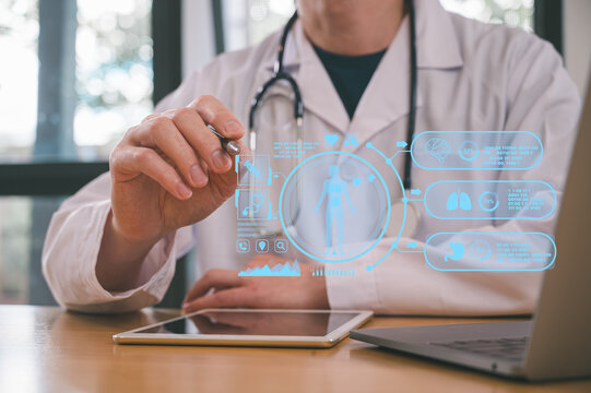 Medical health and wellness concept, Male doctor wearing white cloth using stethoscope tablet and computer analysing patient diagnosis data in medicine and healthcare concept