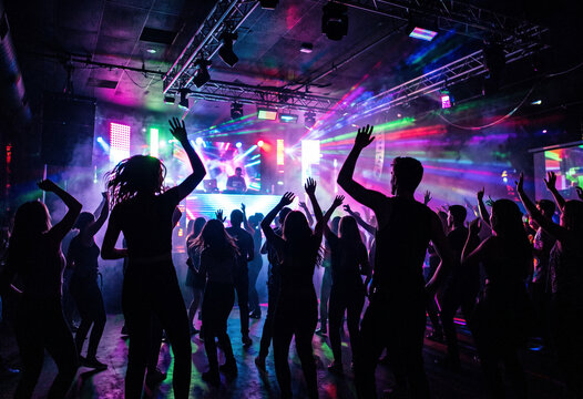 silhouette of disco dancers in night club .