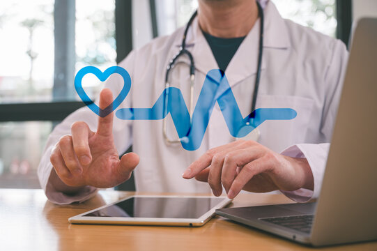 Medical health and wellness concept, male doctor using stethoscope in hospital or clinic with blurred hearts icon representing healthy cardiac rhythm for medical and healthcare concepts