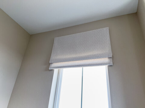 Window With Neutral Roman Shade