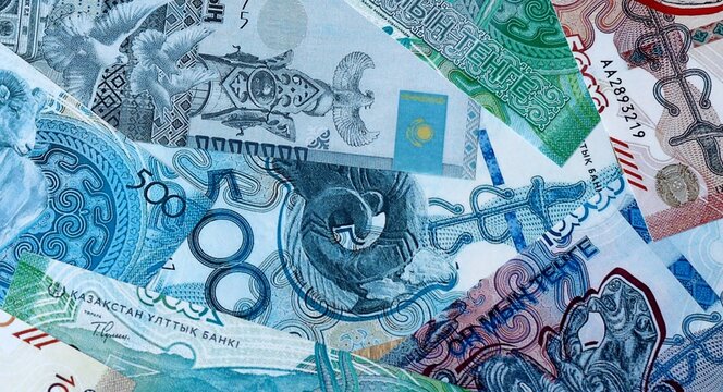 Kazakhstani tenge money bills in pile on table. Kazakhstan KZT currency cash close up
