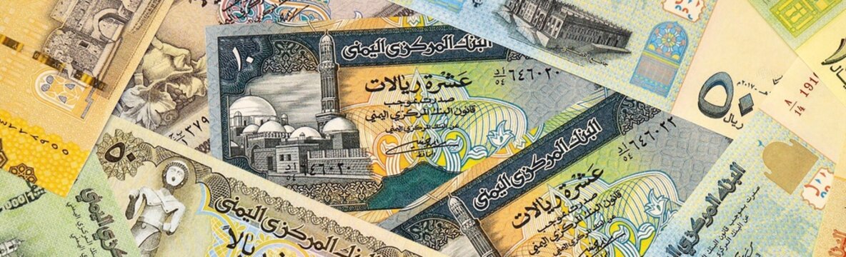 Yemeni rial money bills in pile on table. Yemen YER currency cash close up