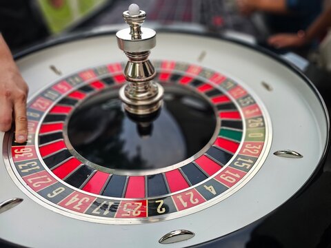 Playing roulette at a casino table with a spinning wheel