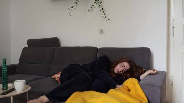 Young woman falls asleep on the couch after an exhausting morning showing how chronic fatigue and low energy can quietly take over an ordinary day at home