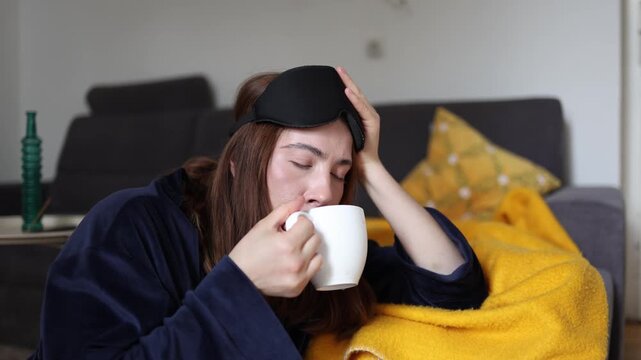 Coffee fights the toughest morning moments as a sleepy young woman hopes every sip will bring back energy clear thoughts and a better mood for the day
