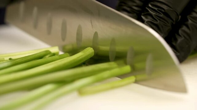 The chef cuts celery for his recipes

