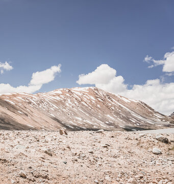 Rocky mountain slopes in the Pamir Mountains in Tajikistan, a minimalist landscape and rocky hills in sunny weather