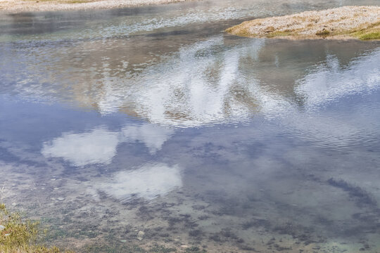 Water surface and shoreline of a high-mountain lake in the Tien Shan Mountains of the Pamirs. Clear mountain water in the lake