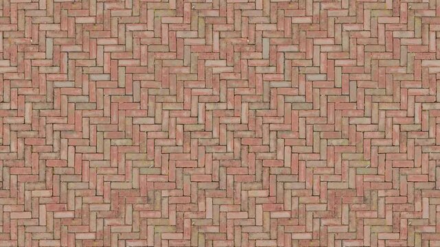 Weathered Red Brick Herringbone Paving Forms a Seamless Loop Background.