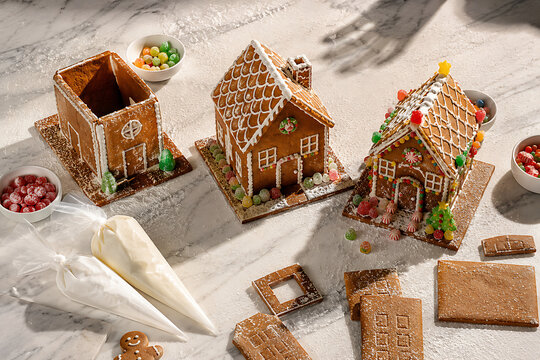 Three Gingerbread Houses Decorated With Candy and Icing for Christmas