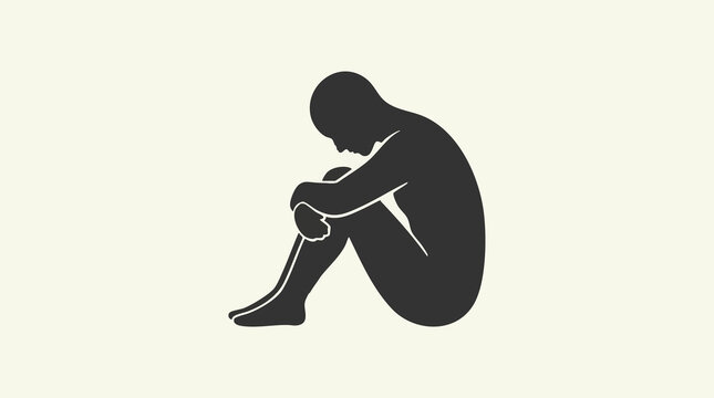 Silhouette of a sad person sitting in a fetal position, depicting depression or loneliness