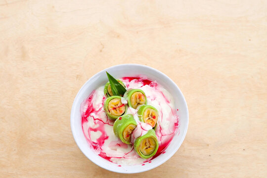 Es Pisang Ijo Makassar dessert with coconut milk and syrup top view