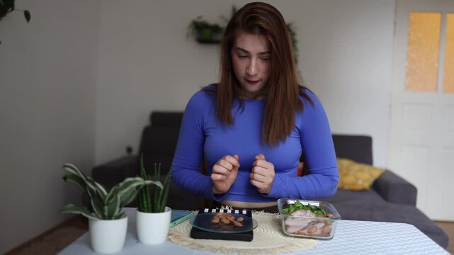 Healthy eating feels harder than expected as a determined woman struggles with every bite while staying committed to a strict calorie controlled weight loss plan