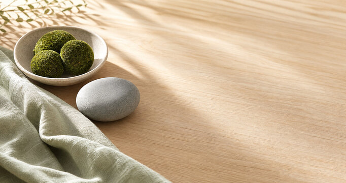 Stone dividing moss spheres and sage linen on desk, nature therapy and healthcare concept