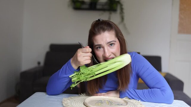 Obsessive calorie counting leaves young woman staring at celery instead of enjoying a meal revealing emotional struggle with restrictive eating and food anxiety