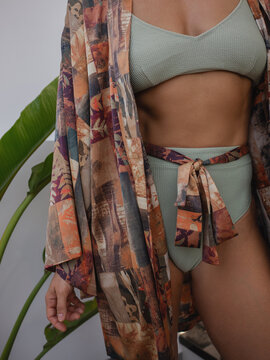 Close up of woman wearing luxury kimono robe over  swimsuit