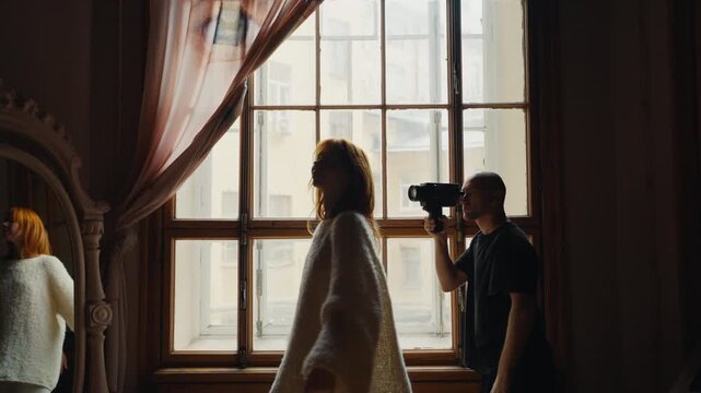 Backstage photoshoot with model and videographer