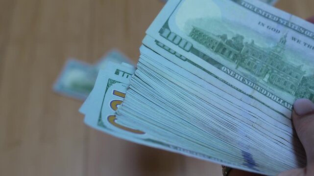 Money dollars cash counting american banknotes on wooden table for financial wealth and investment banking business concepts