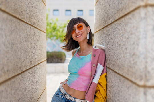 Close-up portrait of attractive joyful girl with amazing smile wears stylish yellow sunglasses and shirt.
