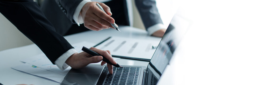Bookkeepers and accounting manager consultation about asset, balance sheet and yearly tax and analysis data figures to plan business strategies and the results of their successful teamwork.