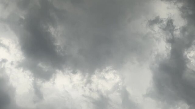 Dramatic, moody grey clouds gather in a stormy sky, hinting at impending rain.