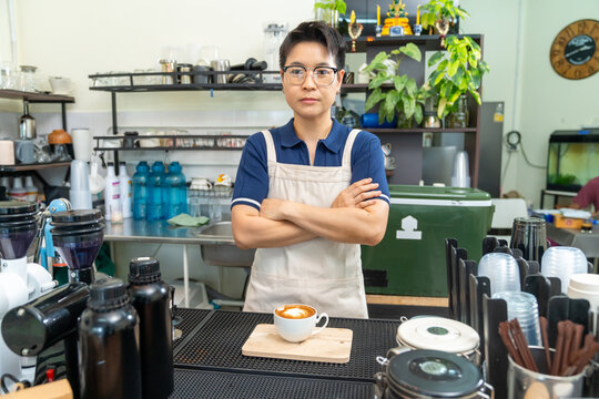 Portrait of Barista serving cafe latte to customer at cafe counter, professional beverage drink preparation specialty coffee and tea shop, small business hospitality and takeaway drink service
