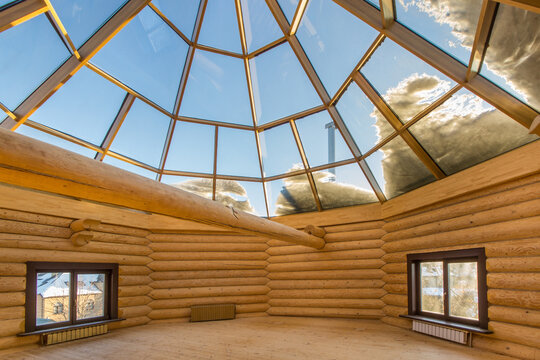 Attic with windows in a rustic log house. The domed glass roof gives a lot of light. Unfurnished.