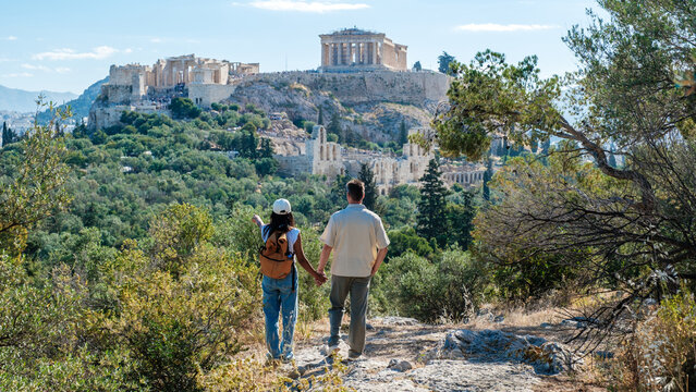 Strolling hand in hand towards the Acropolis in Athens, Greece on a sunny day