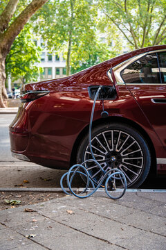 Ein E-Auto wird an einem Ladebordstein auf der K&Ouml; mit einem Kabel aufgeladen, D&uuml;sseldorf, Deutschland